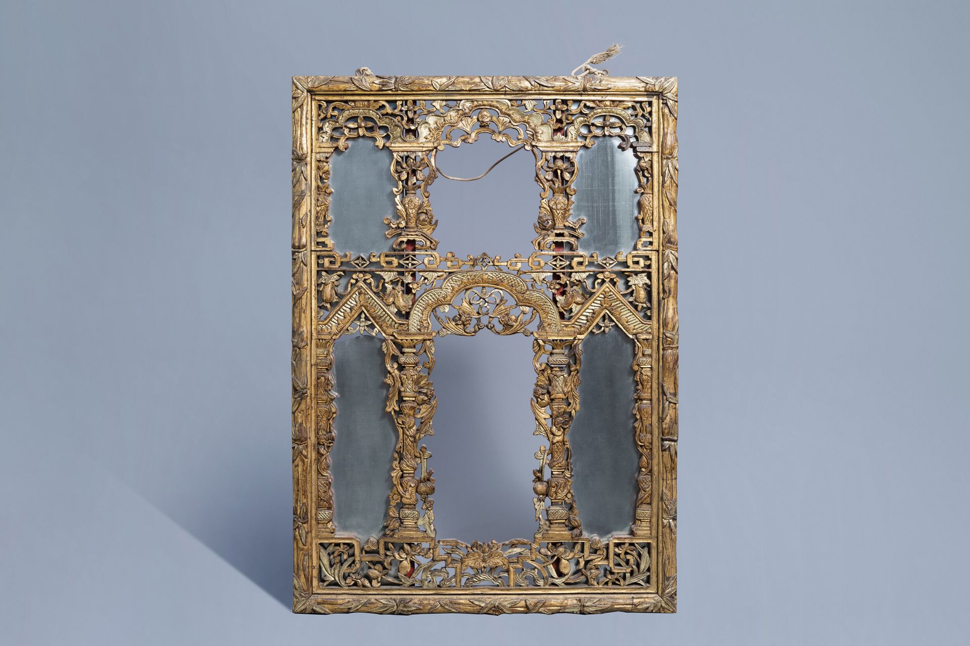 A Chinese open worked gilt wooden mirror, 19th C.