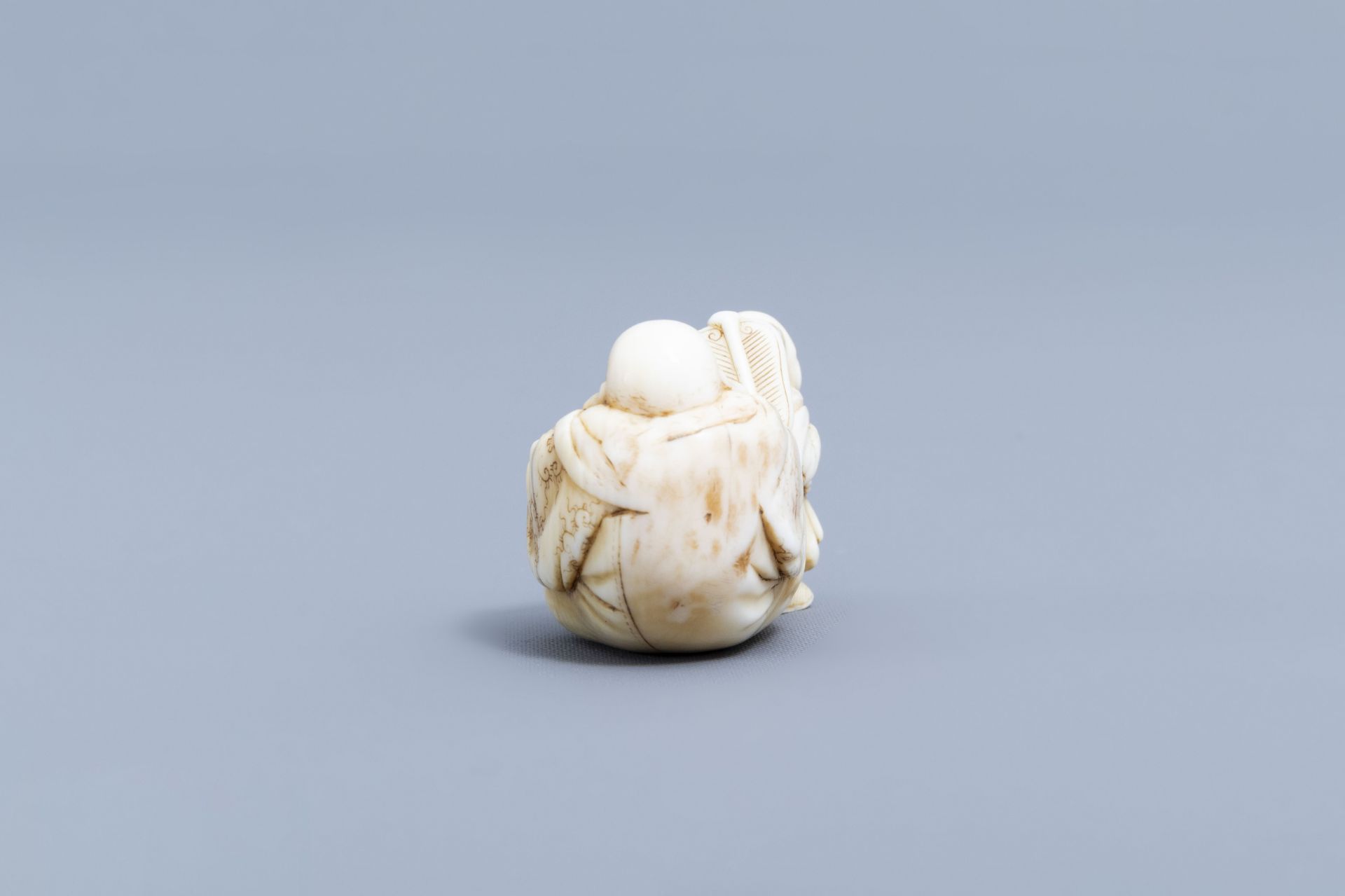 A Japanese ivory netsuke of a laughing Buddha with his servant, signed Shinsai, Edo - Image 4 of 9