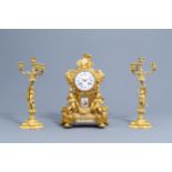 A French gilt bronze mounted Sevres style clock and a pair of Louis XV style candelabra, 19th C.