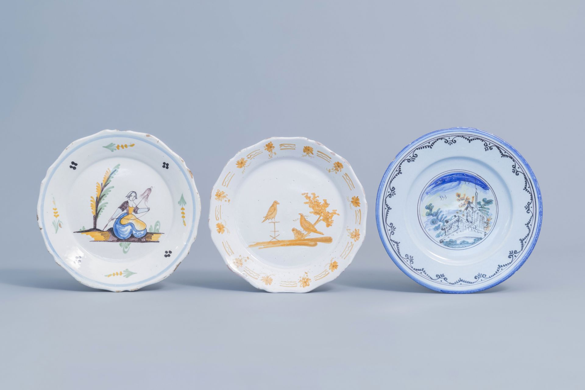 A fine Italian polychrome Savona 'landscape' plate and two various French plates, 18th/19th C.