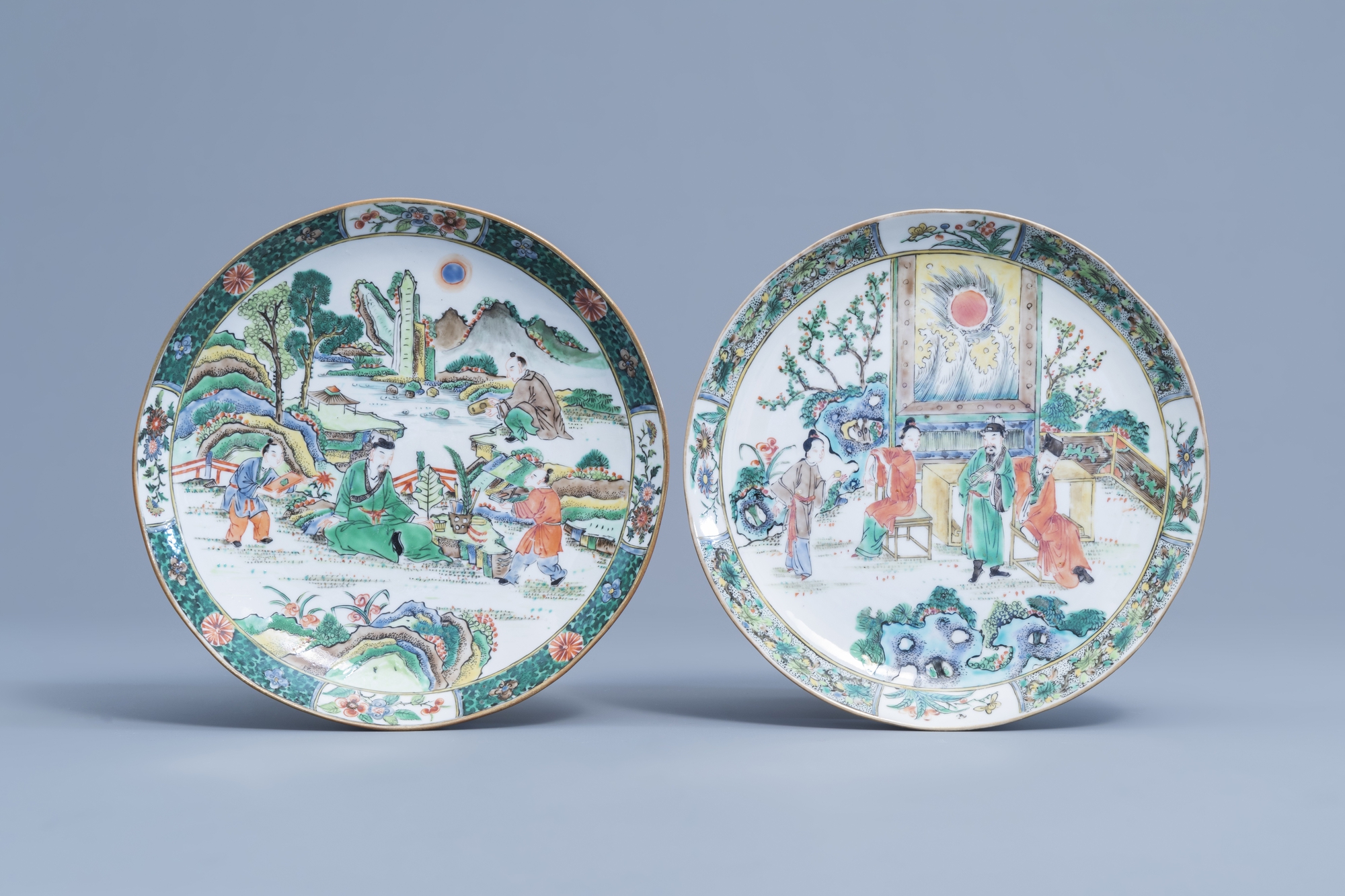 Two Chinese Canton famille verte plates with figures on a terrace, 19th C.