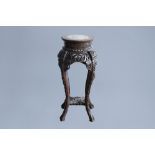 A Chinese carved wood stand with marble top, 19th/20th C.