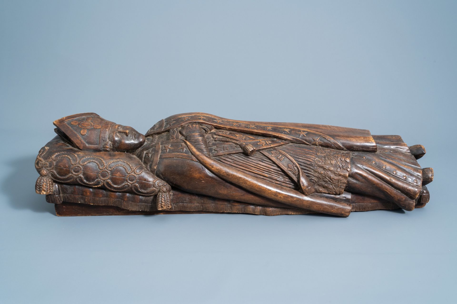 A French or Flemish carved wooden figure of a bishop on his deathbed, most probably Saint Bavo of Gh