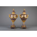 An imposing pair of gilt bronze mounted red porphyry cassolettes, 19th/20th C.