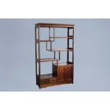 A Chinese wooden display cabinet with floral design, 20th C.