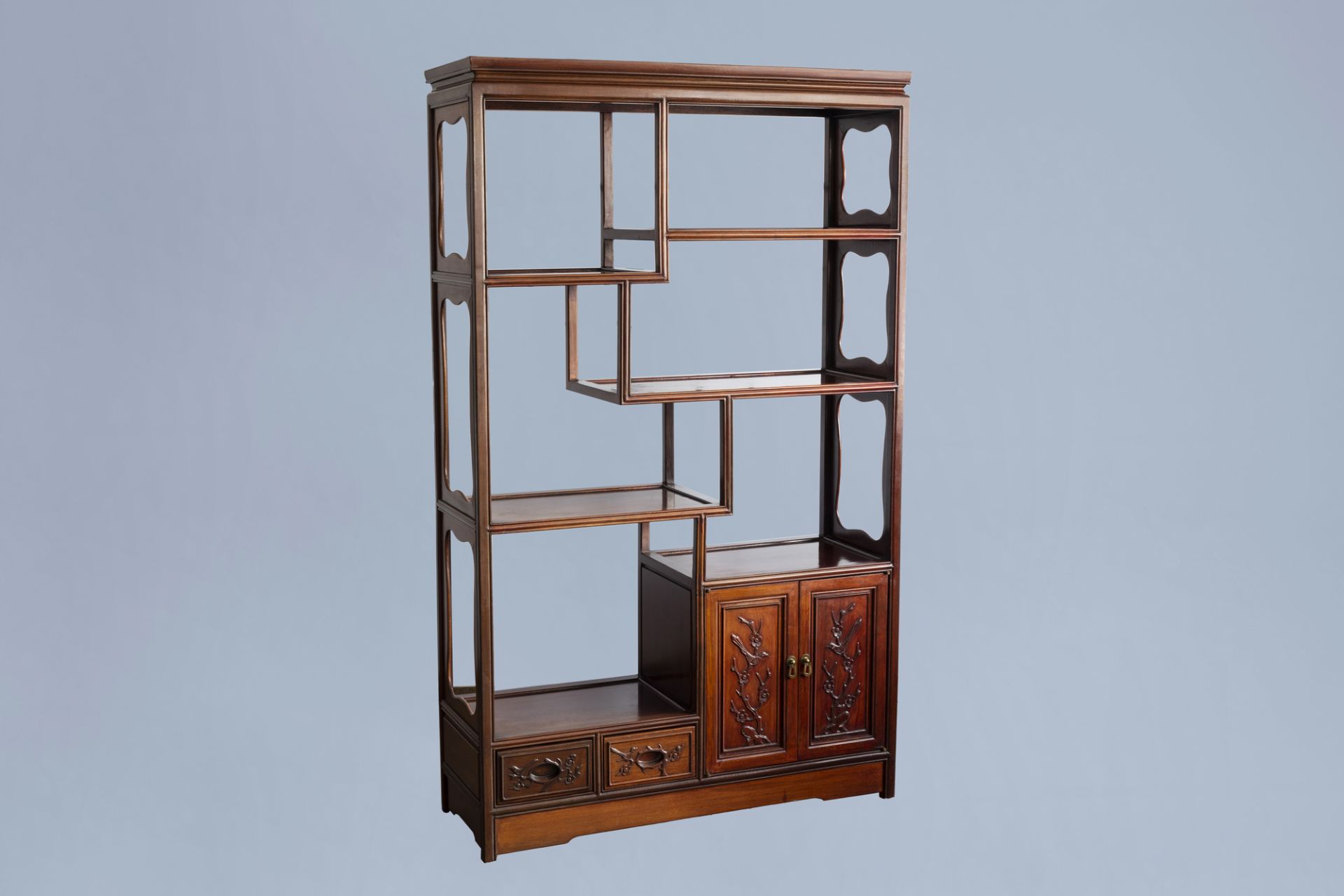 A Chinese wooden display cabinet with floral design, 20th C.