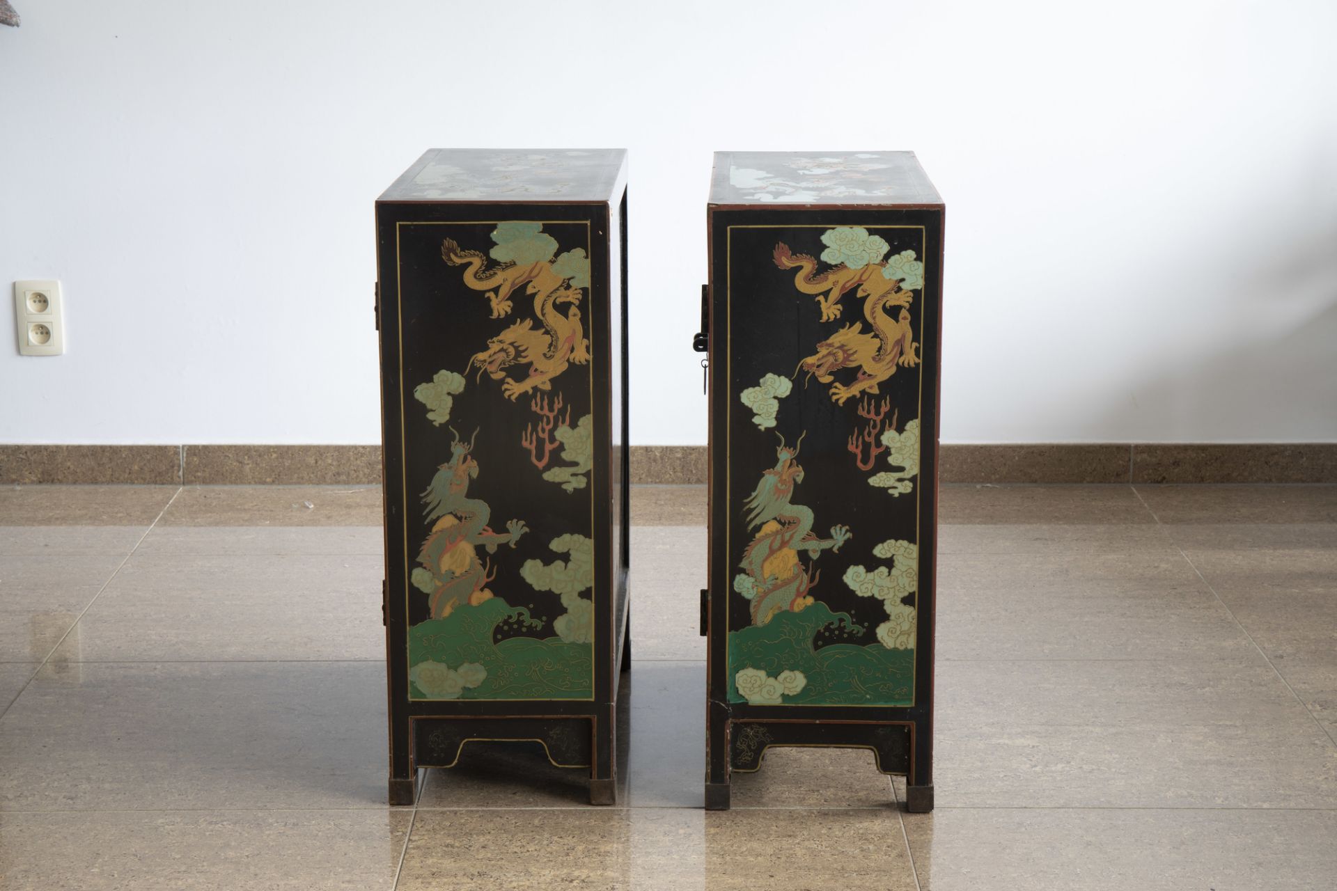 A pair of Chinese black lacquered wooden 'dragons chasing the pearl' two-door cabinets, 20th C. - Image 5 of 7