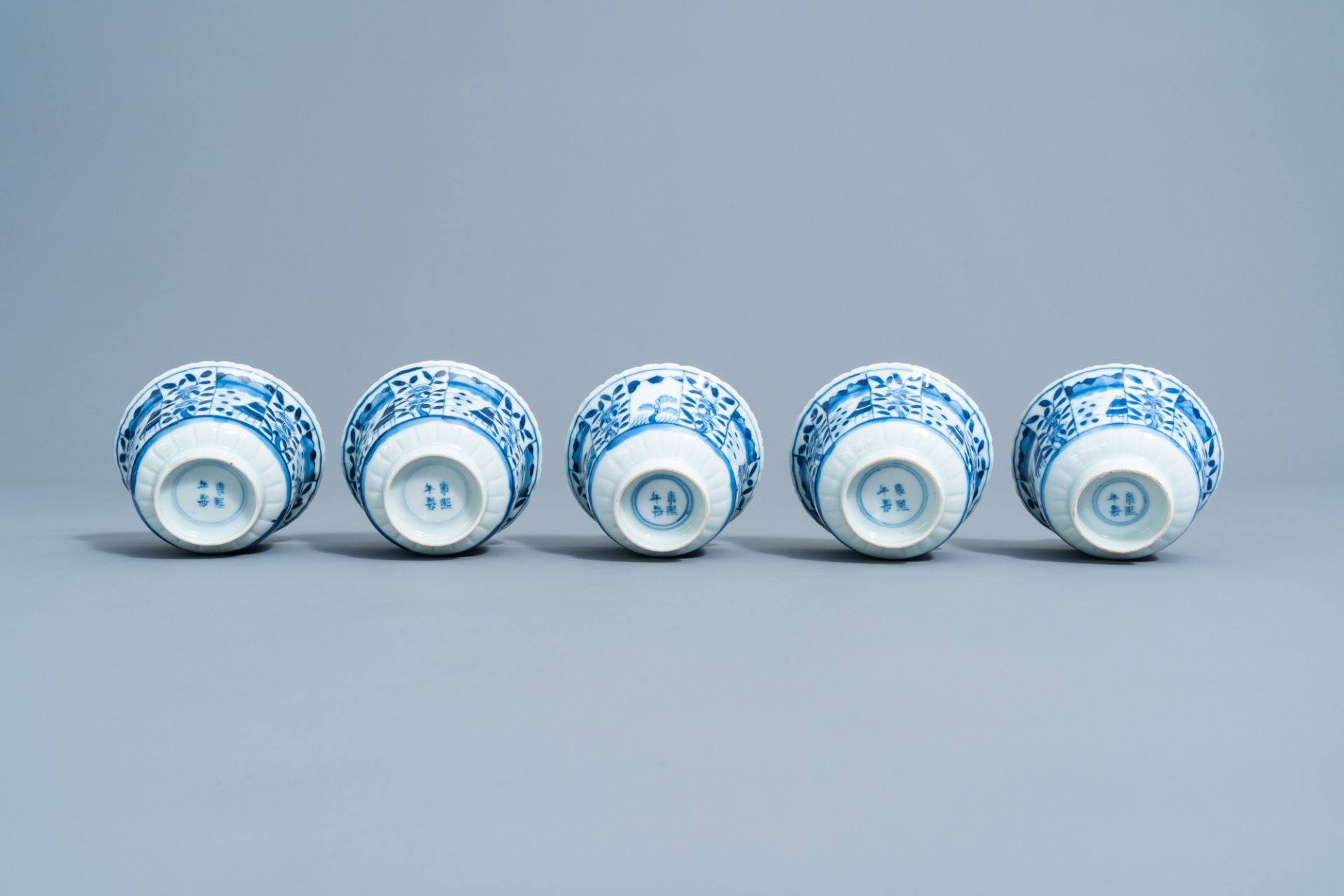Five Chinese blue and white cups and saucers with landscapes and floral design, Kangxi mark, 19th C. - Image 9 of 9