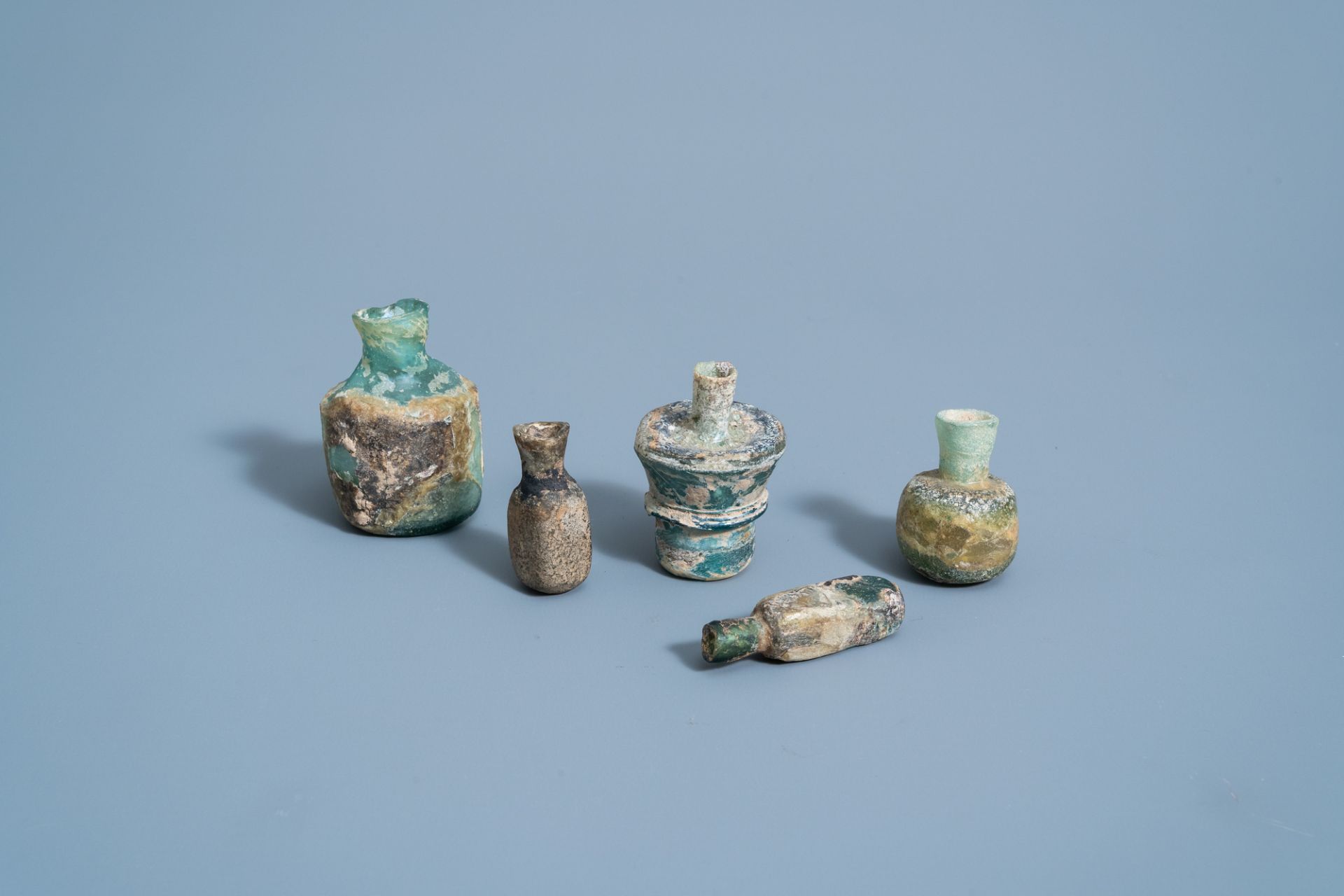 Five various soda glass bottles, jars and flasks, Roman period