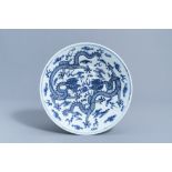A Chinese blue and white 'dragons chasing the pearl' charger, 19th C.