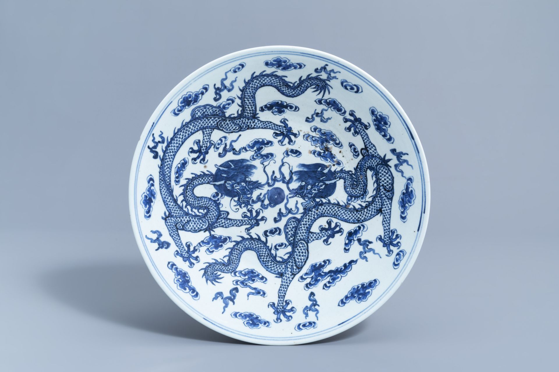 A Chinese blue and white 'dragons chasing the pearl' charger, 19th C.