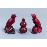 A pair of Chinese red glazed parrots and a monochrome red double gourd vase, 20th C.