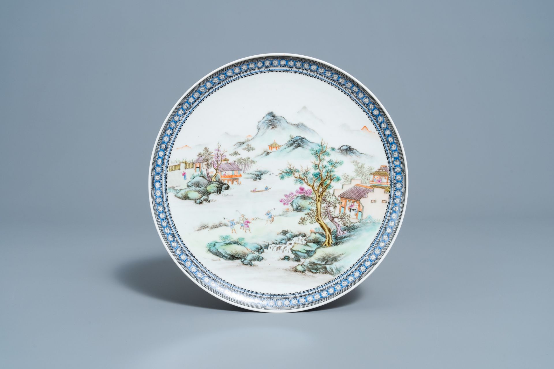 A Chinese famille rose plate with an animated river landscape, Qianlong mark, Republic, 20th C.