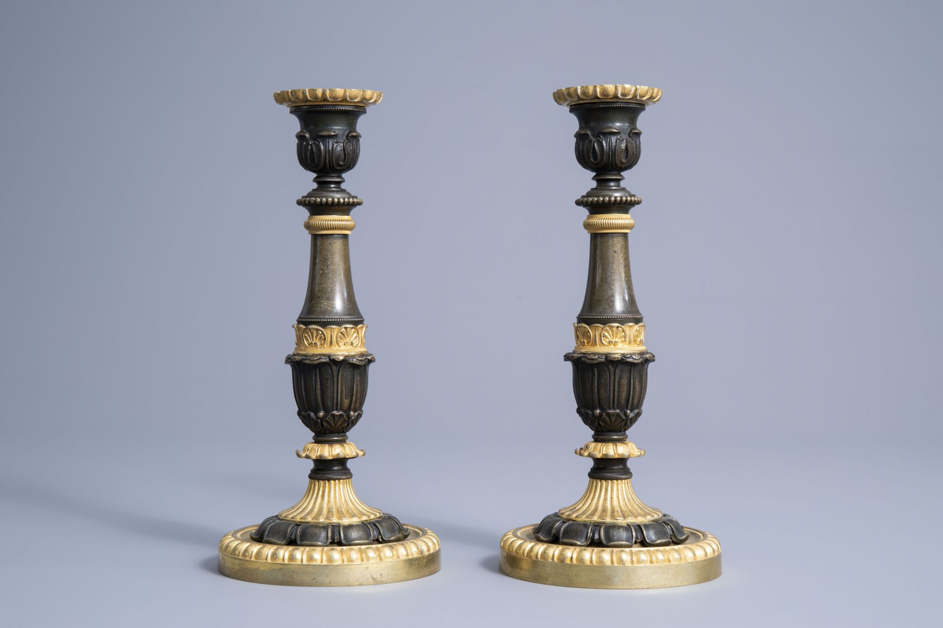 A pair of French gilt and patinated bronze candlesticks with acanthus leaves, 19th C. - Image 2 of 7