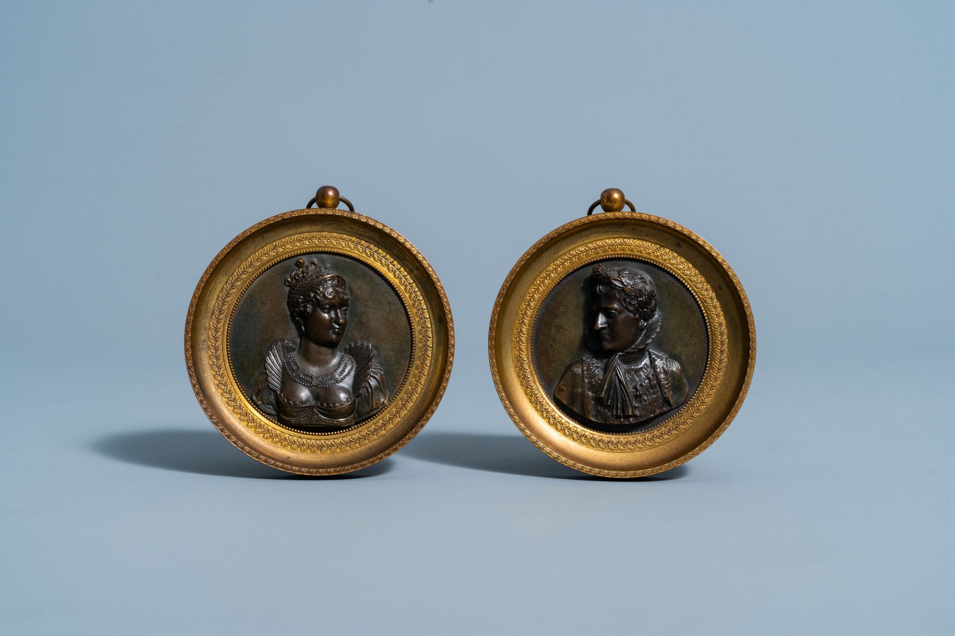 A pair of bronze Empire alto relievo plaques depicting the profile portraits of Napoleon and his wif