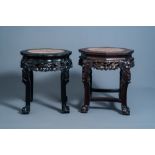 Two Chinese carved wooden stands with marble top, 19th/20th C.