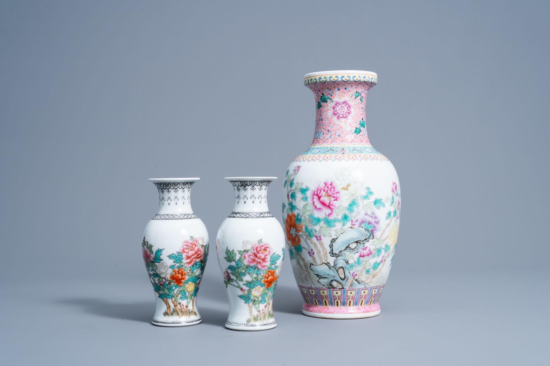 A pair of Chinese famille rose vases and a vase with floral design, 20th C.