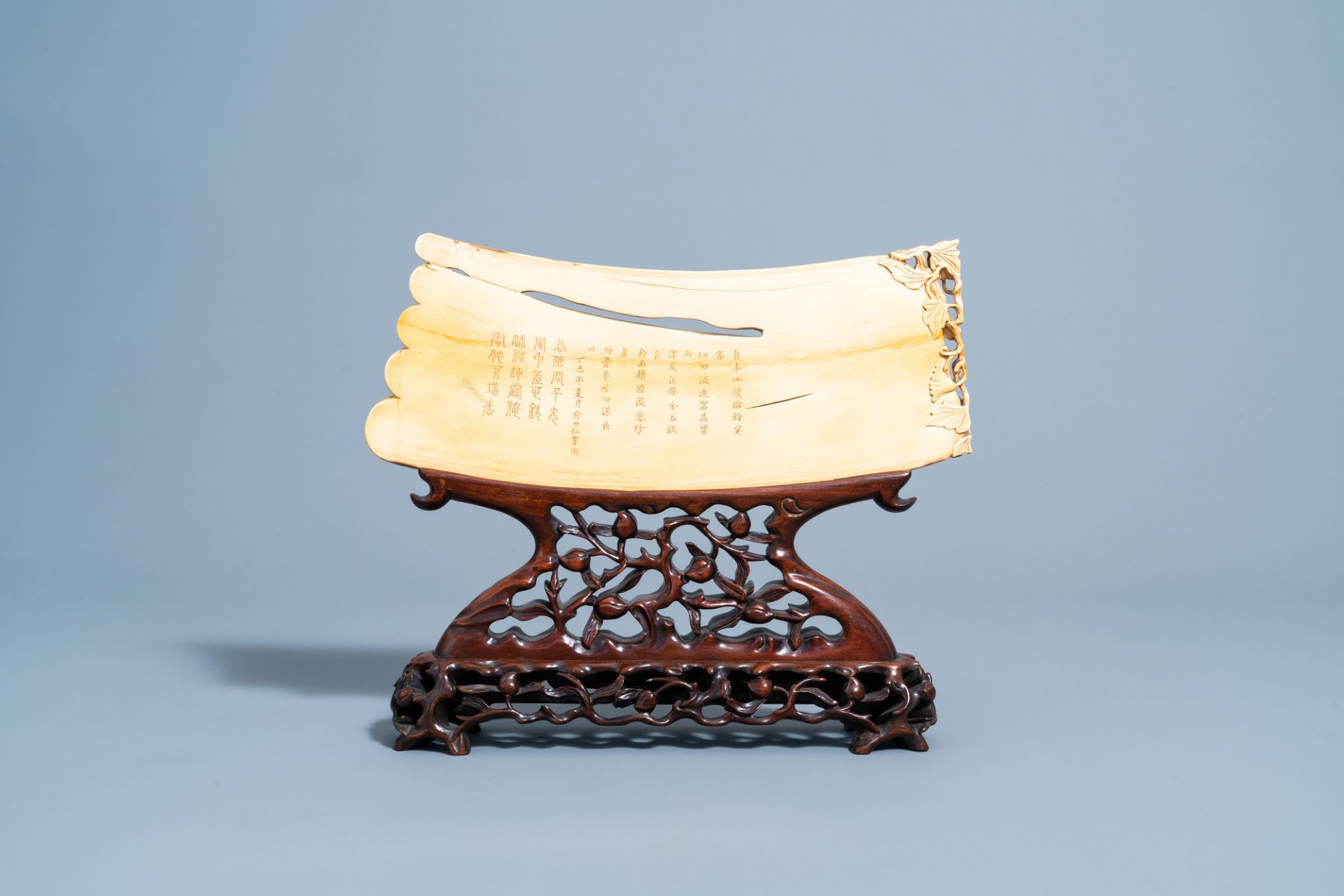 A Chinese richly carved ivory plaque with an animated city view on a wooden base, Canton, 19th C. - Image 4 of 15