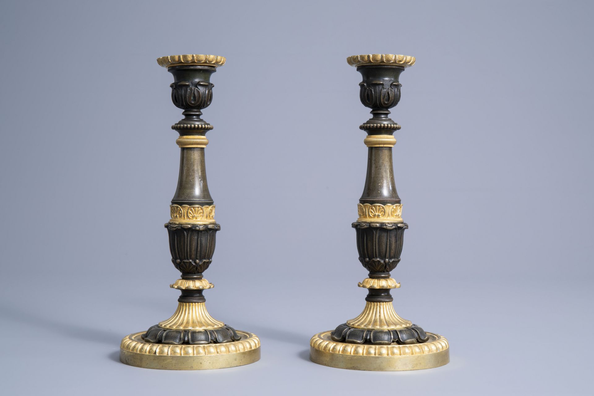 A pair of French gilt and patinated bronze candlesticks with acanthus leaves, 19th C. - Image 5 of 7