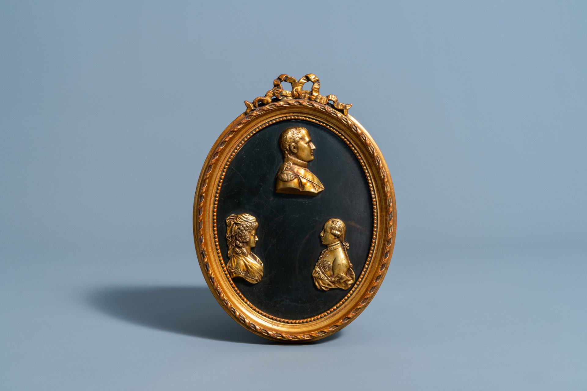 A French red copper plaque with three gilt profile busts of Napoleon Bonaparte, Louis XVI and Marie-