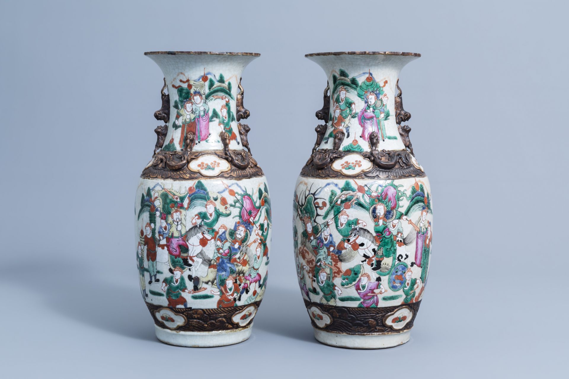 A pair of Chinese Nanking crackle glazed famille rose 'warrior' vases, 19th/20th C.