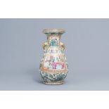 A Chinese Canton famille rose bottle vase with elephant head shaped handles, 19th C.