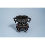 A Chinese bronze censer on wooden stand, Yuan/Ming