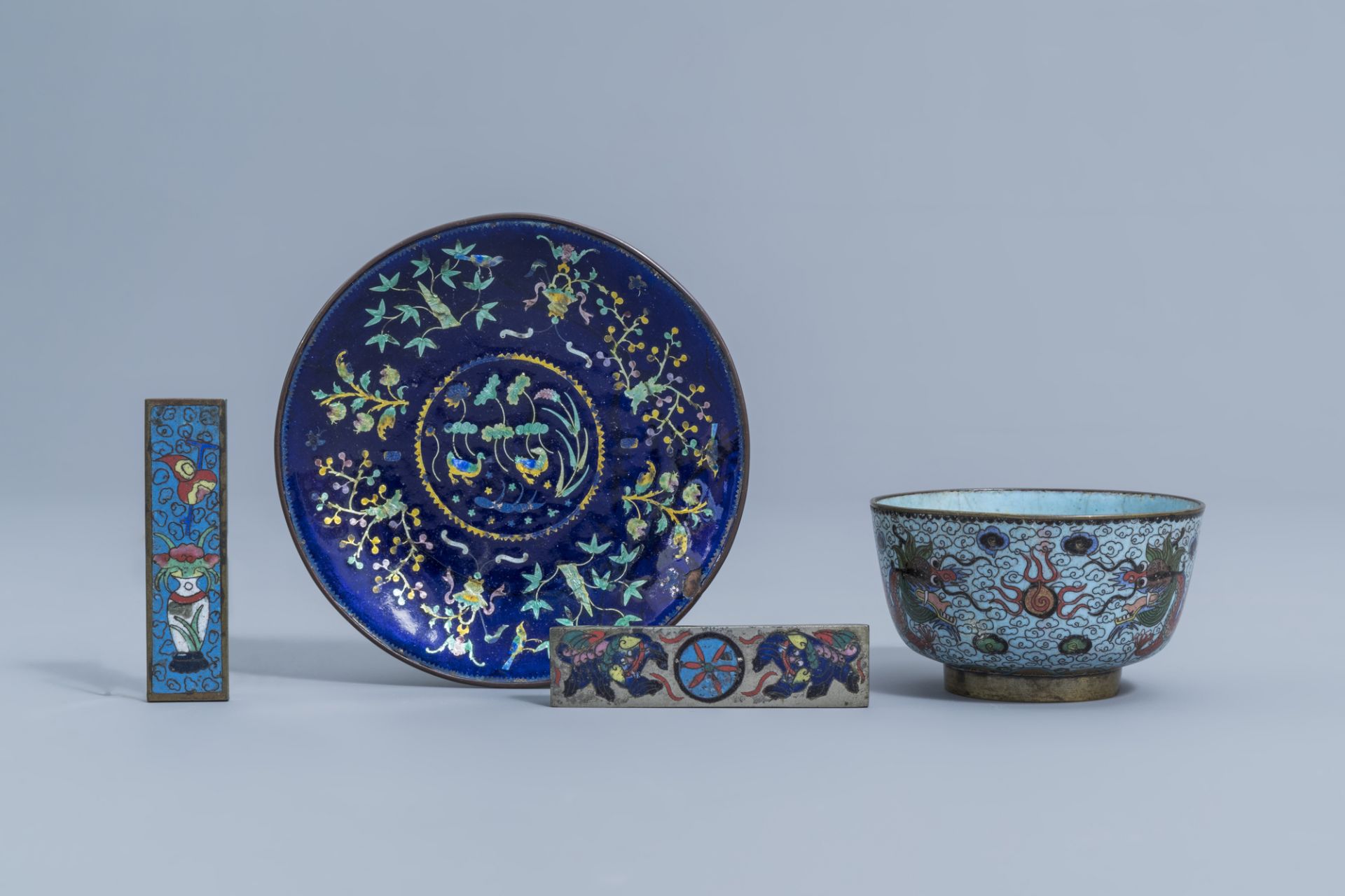 A Chinese cloisonne 'dragons' bowl, an enamel caucer with floral design and two small cloisonne scro