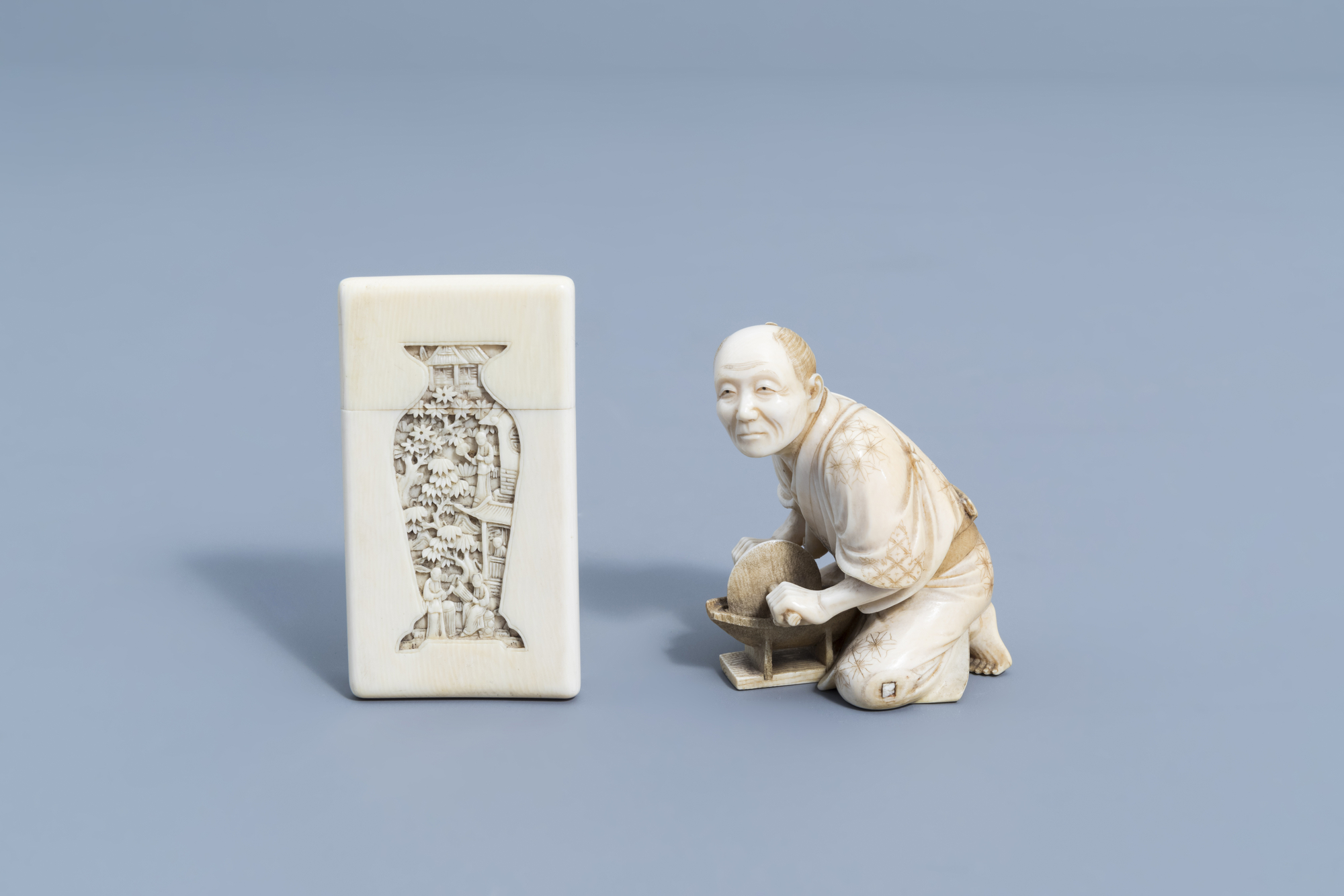 A Chinese carved Canton ivory card case & a signed Japanese ivory okimono of a man, Meiji, 19th C.