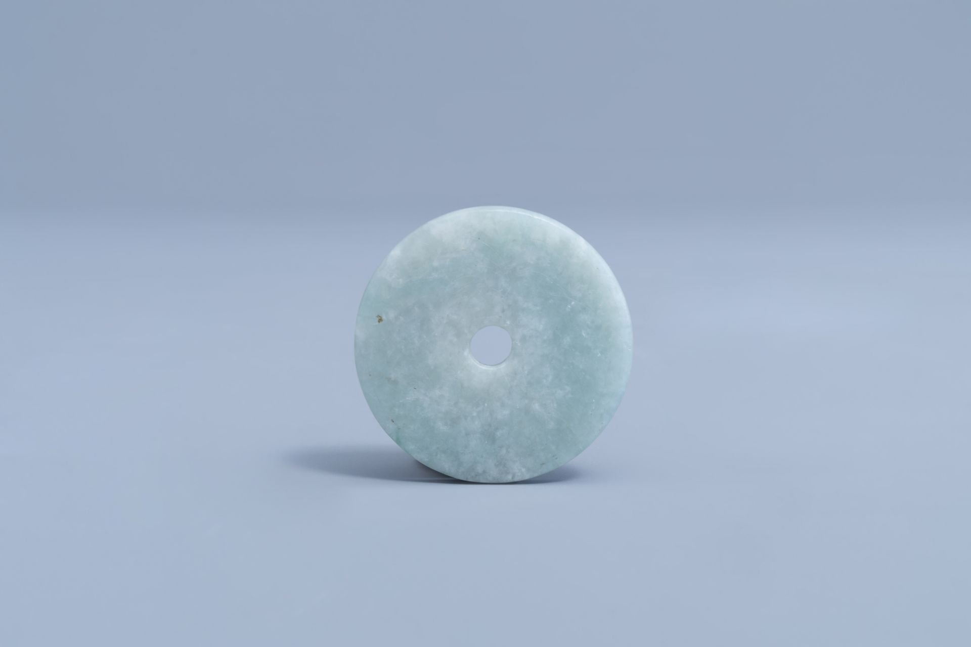 A Chinese pale celadon jade bi disc, 19th/20th C.