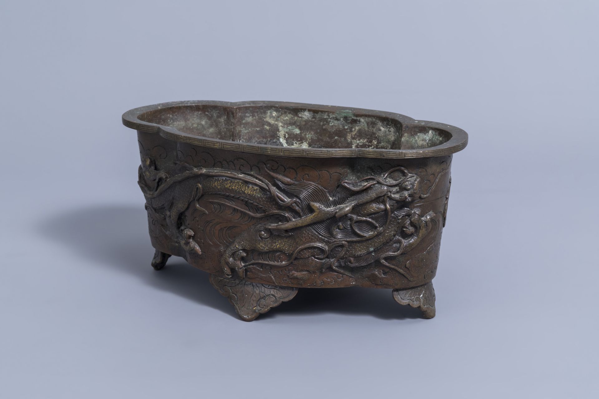 A Japanese four-lobed bronze 'dragon and phoenix' jardiniere, Meiji, 19th C.