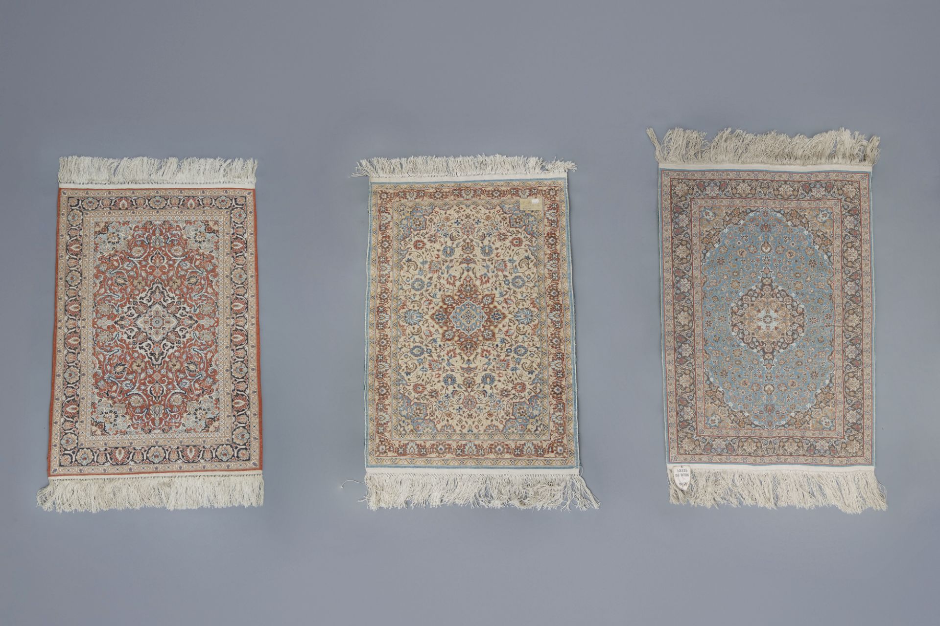 Three Oriental rugs with floral design and a central medallion, silk on cotton, 20th C. - Image 5 of 5