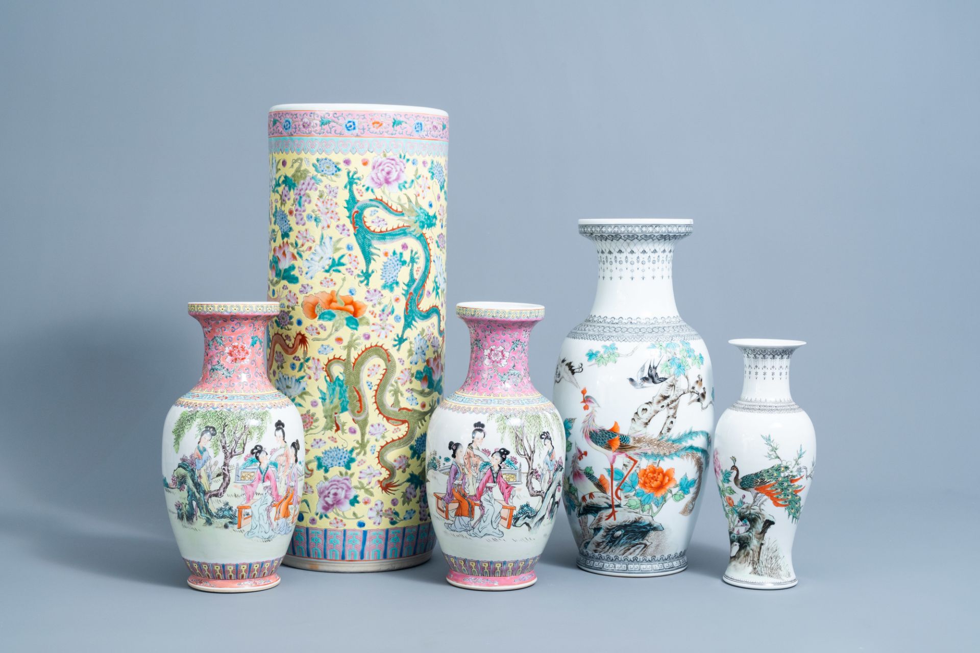 Four various Chinese famille rose vases and a 'dragons' umbrella stand, 20th C.