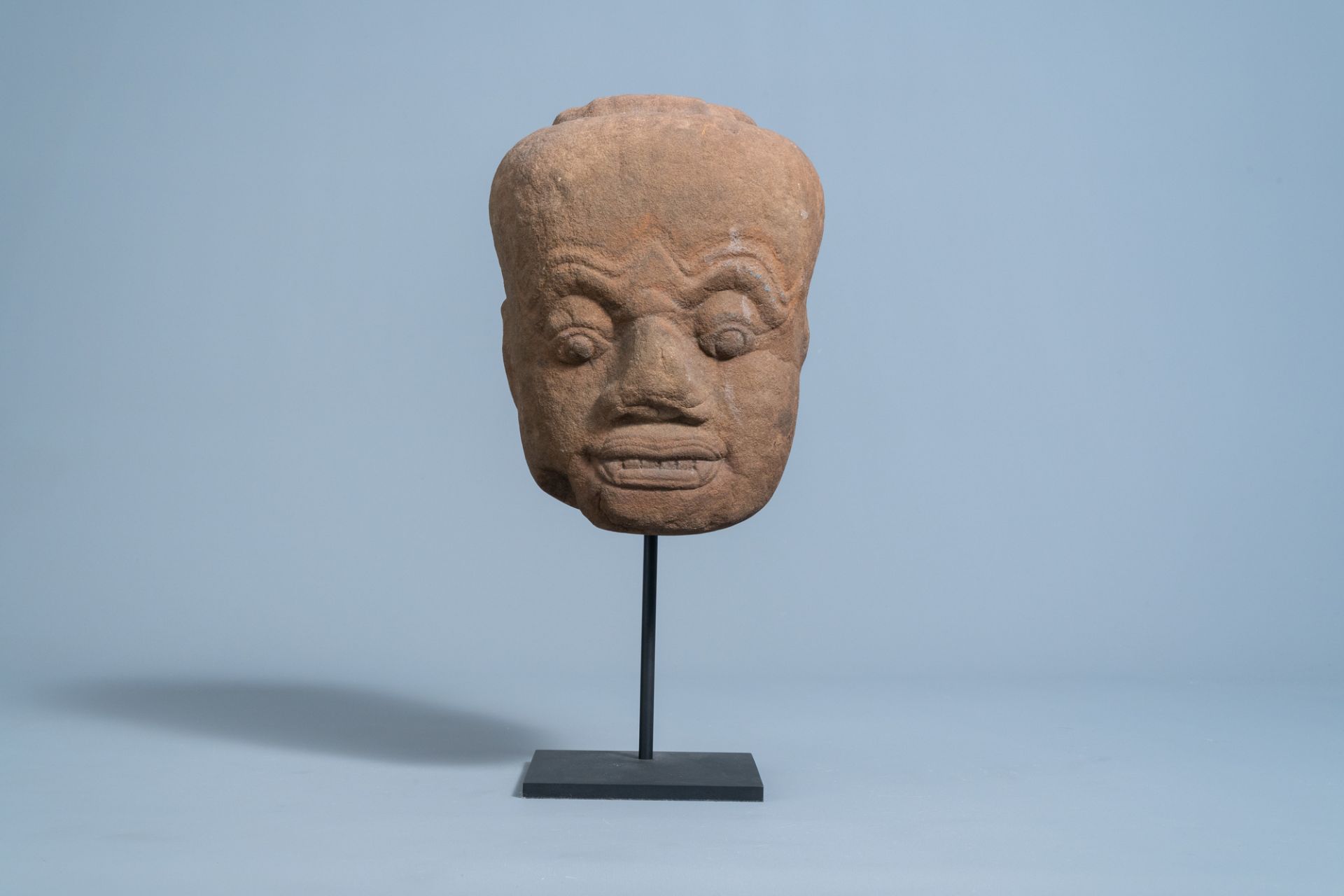 A Khmer sandstone head of a Dvarapala guardian figure, 11th C. or later