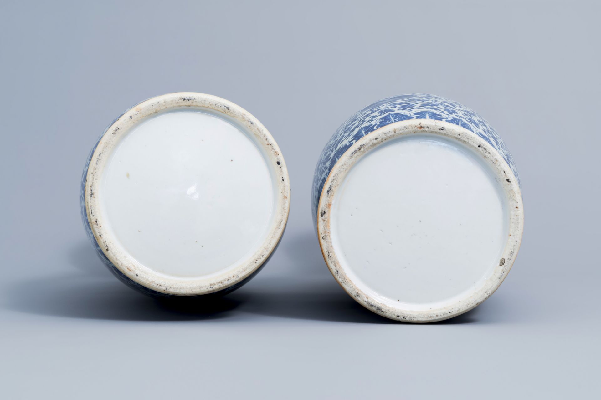 A pair of Chinese blue and white 'lotus scroll' vases with relief design, 19th C. - Image 6 of 6
