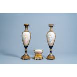 A pair of French Sevres style gold layered blue ground vases with sweet scenes by Collot and a bowl