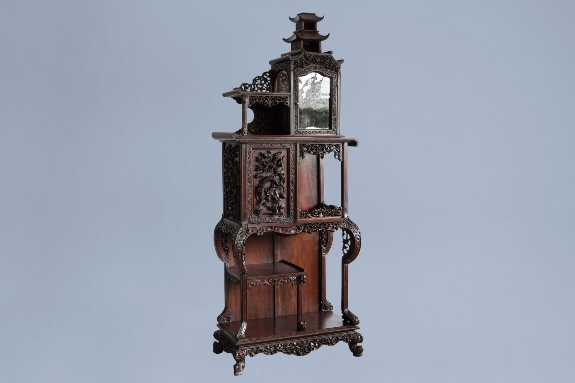 A Chinese reticulated wooden 'dragon' display cabinet, ca. 1900