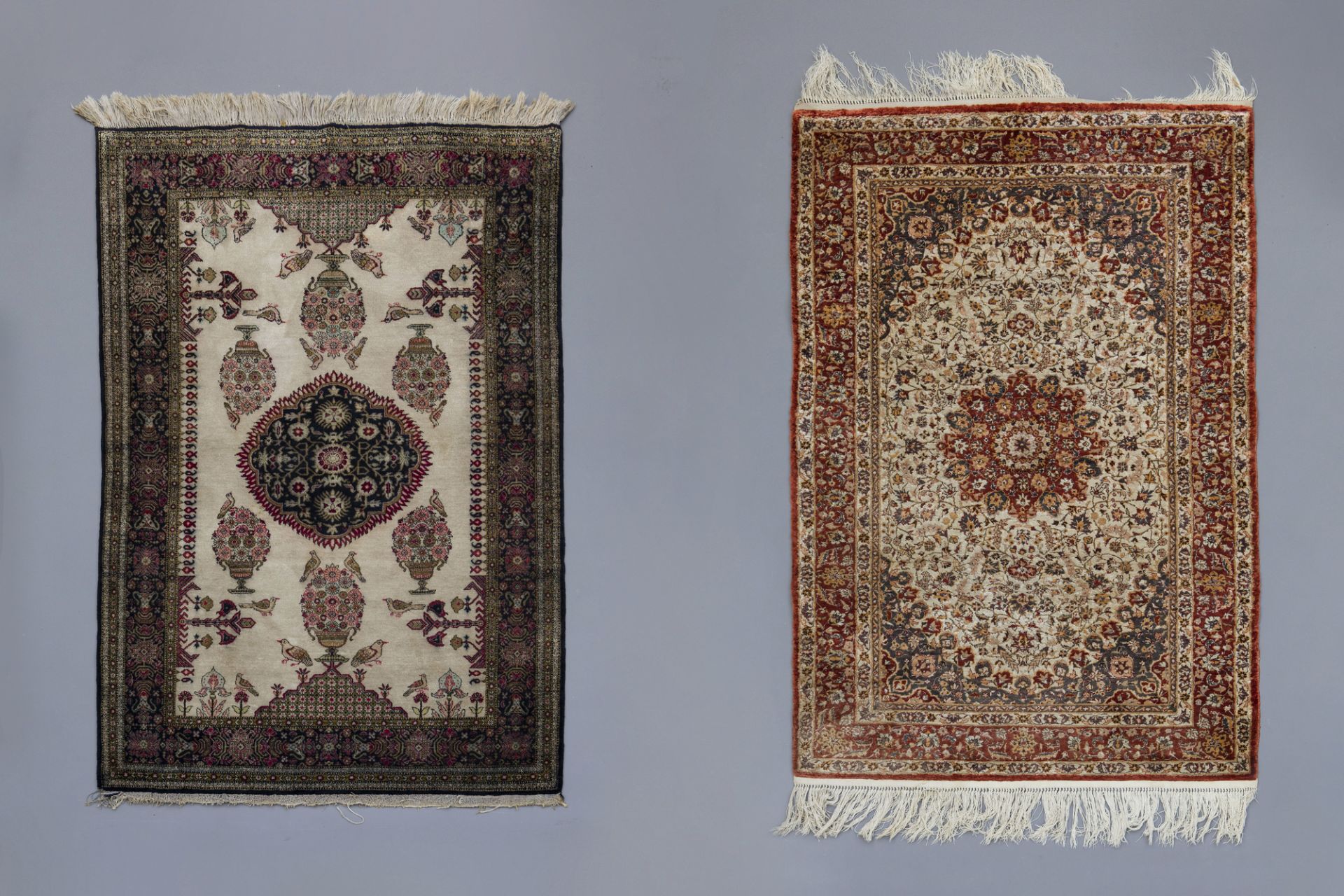 Two Oriental rugs with floral design, birds and a central medallion, silk on cotton, 20th C.