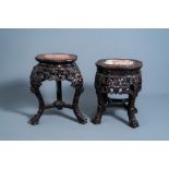 Two Chinese carved wooden stands with marble top, 19th/20th C.