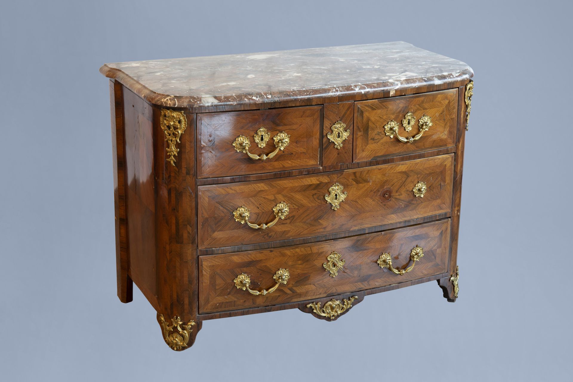 A French Regence style gilt bronze mounted chest of drawers with marble top, 18th C.