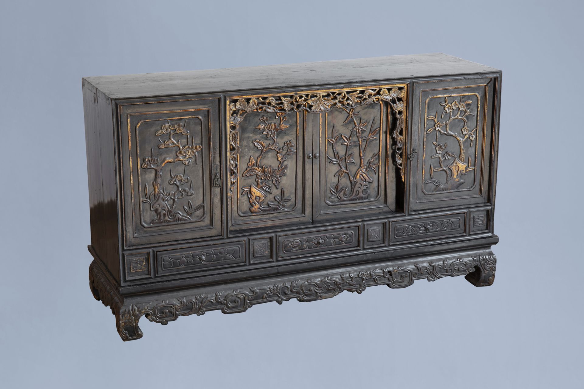 A Chinese lacquered, partly gilt and carved wooden 'four seasons' sideboard, 19th/20th C.