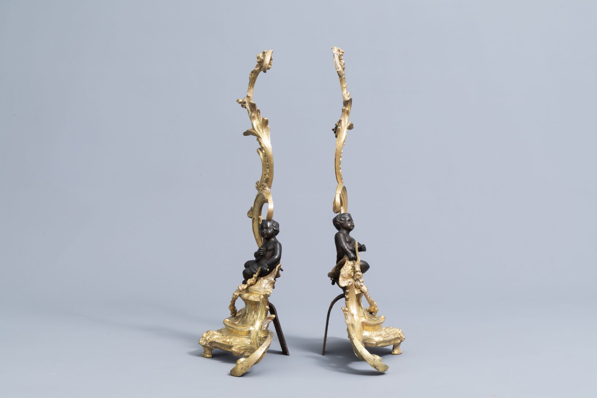 A pair of French Louis XV style patinated and gilt bronze andirons with putti, 19th C. - Image 4 of 15
