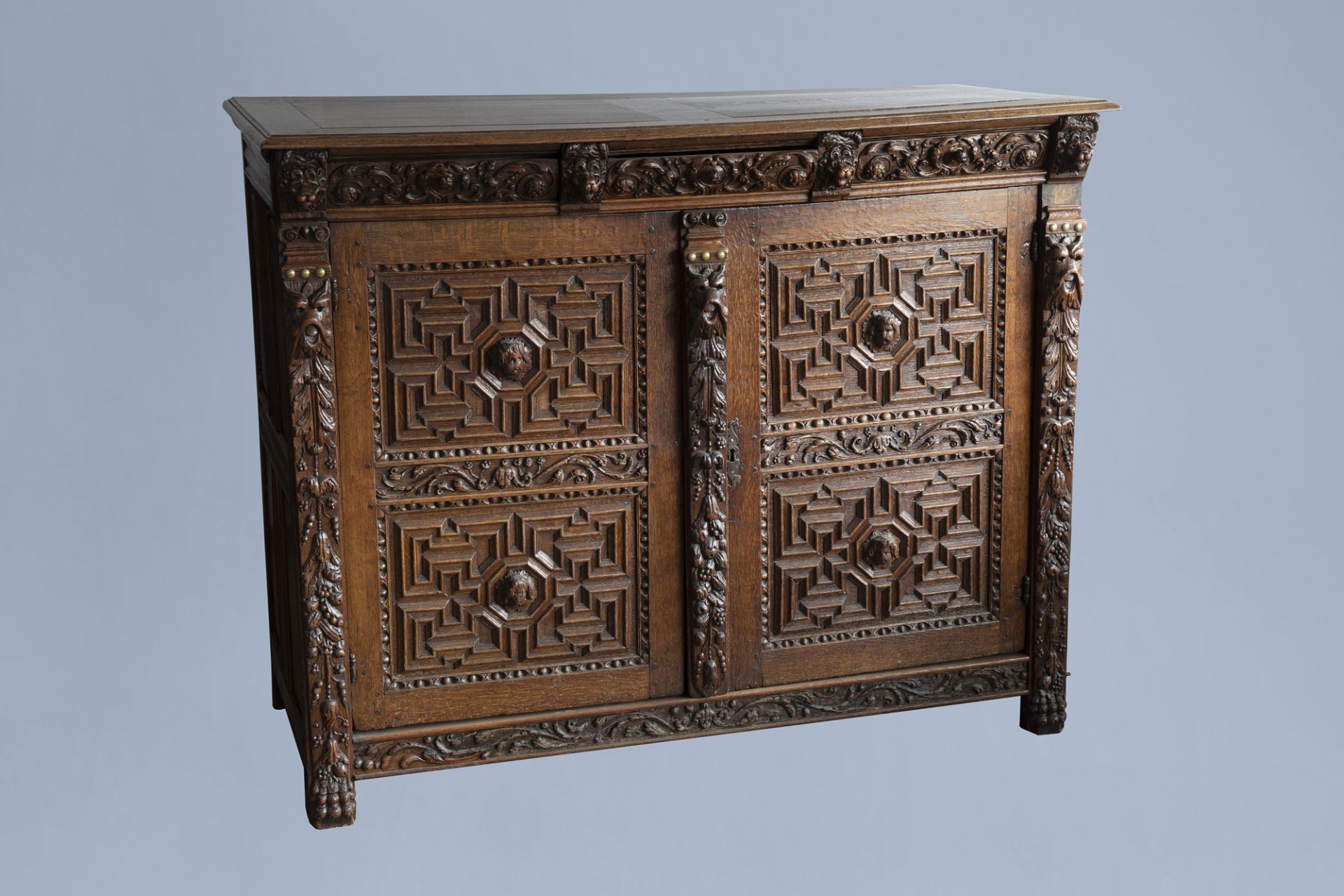 An oak wooden buffet dresser with floral design and lion heads, the Netherlands, 17th C. and later