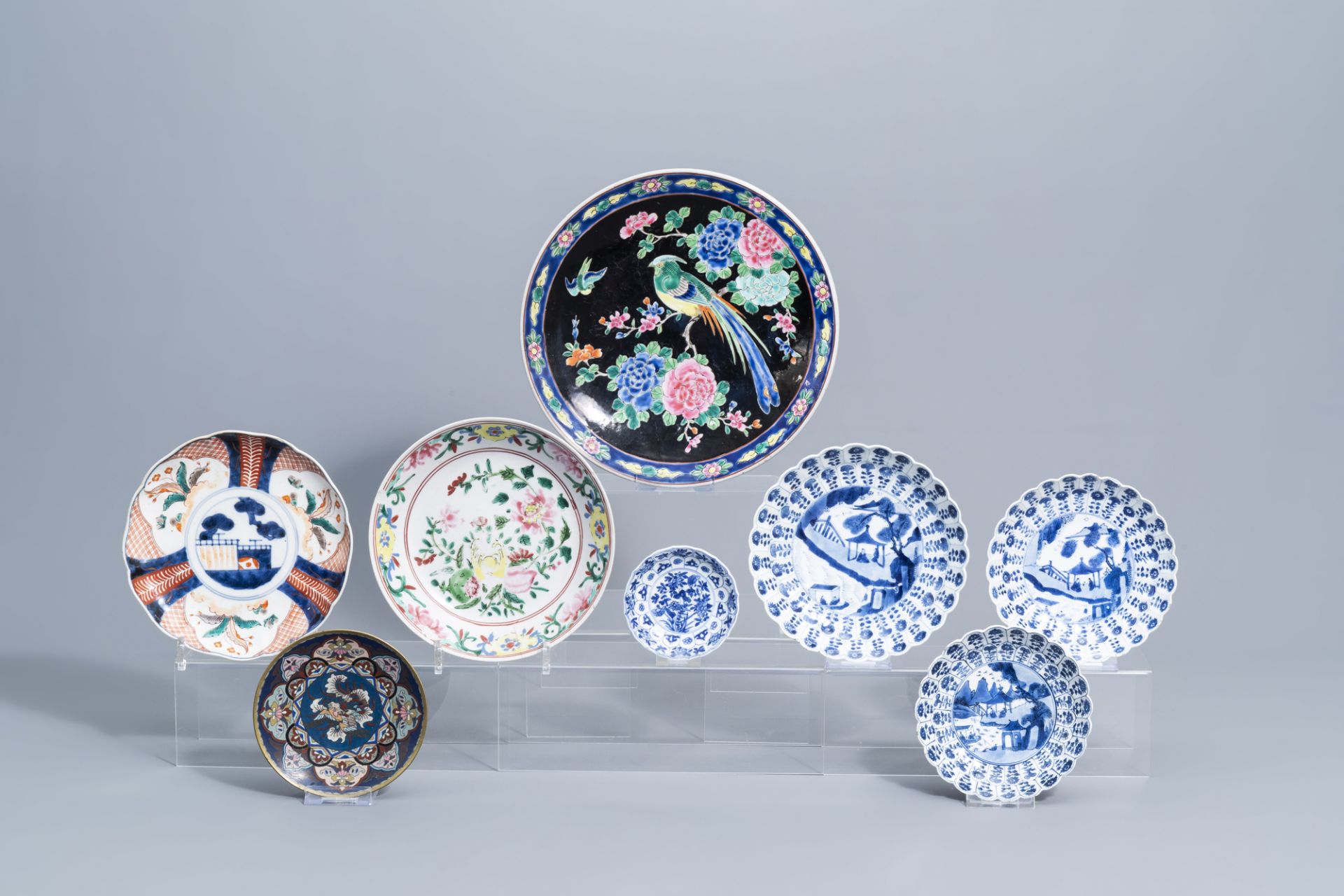 A varied collection of Chinese and Japanese blue, white, famille rose and Imari porcelain and a cloi