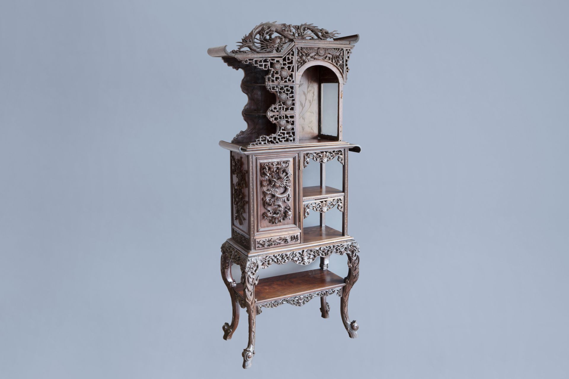 A Chinese reticulated wooden 'dragons' display cabinet, ca. 1900