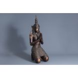 A patinated and gilt wooden kneeling Buddha figure, Thailand, 19th/20th C.