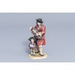 A polychrome Capodimonte porcelaine group with a street musician and his son, Italy, 19th/20th C.