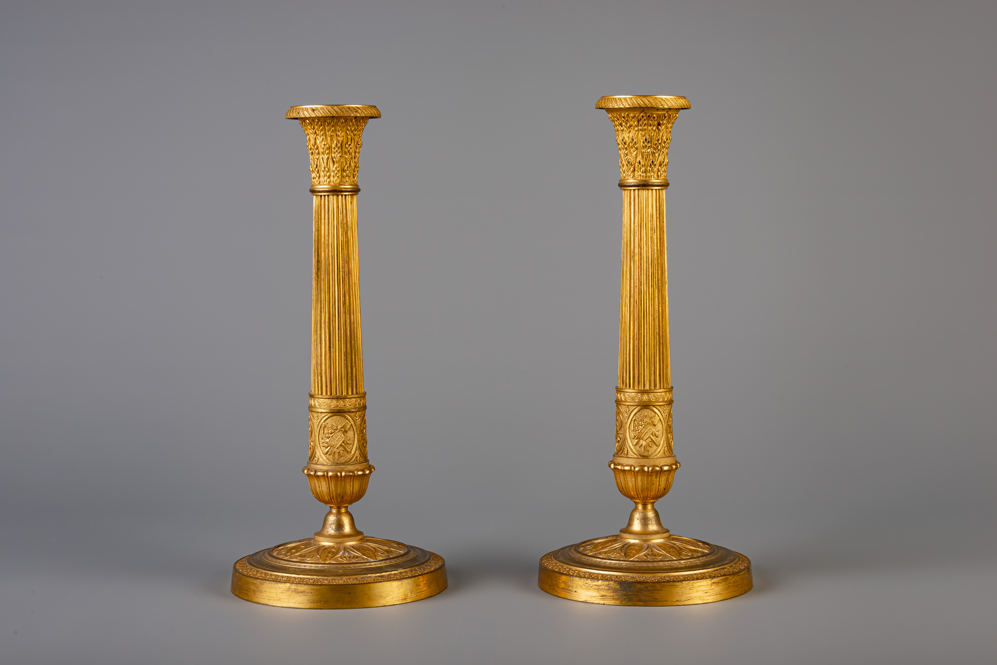 A pair of French Neoclassical gilt bronze candlesticks, 19th C. - Image 3 of 7