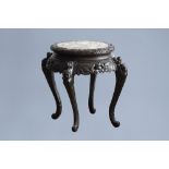 A Chinese or Japanese wooden table with marble top and dragon shaped legs, 20th C.
