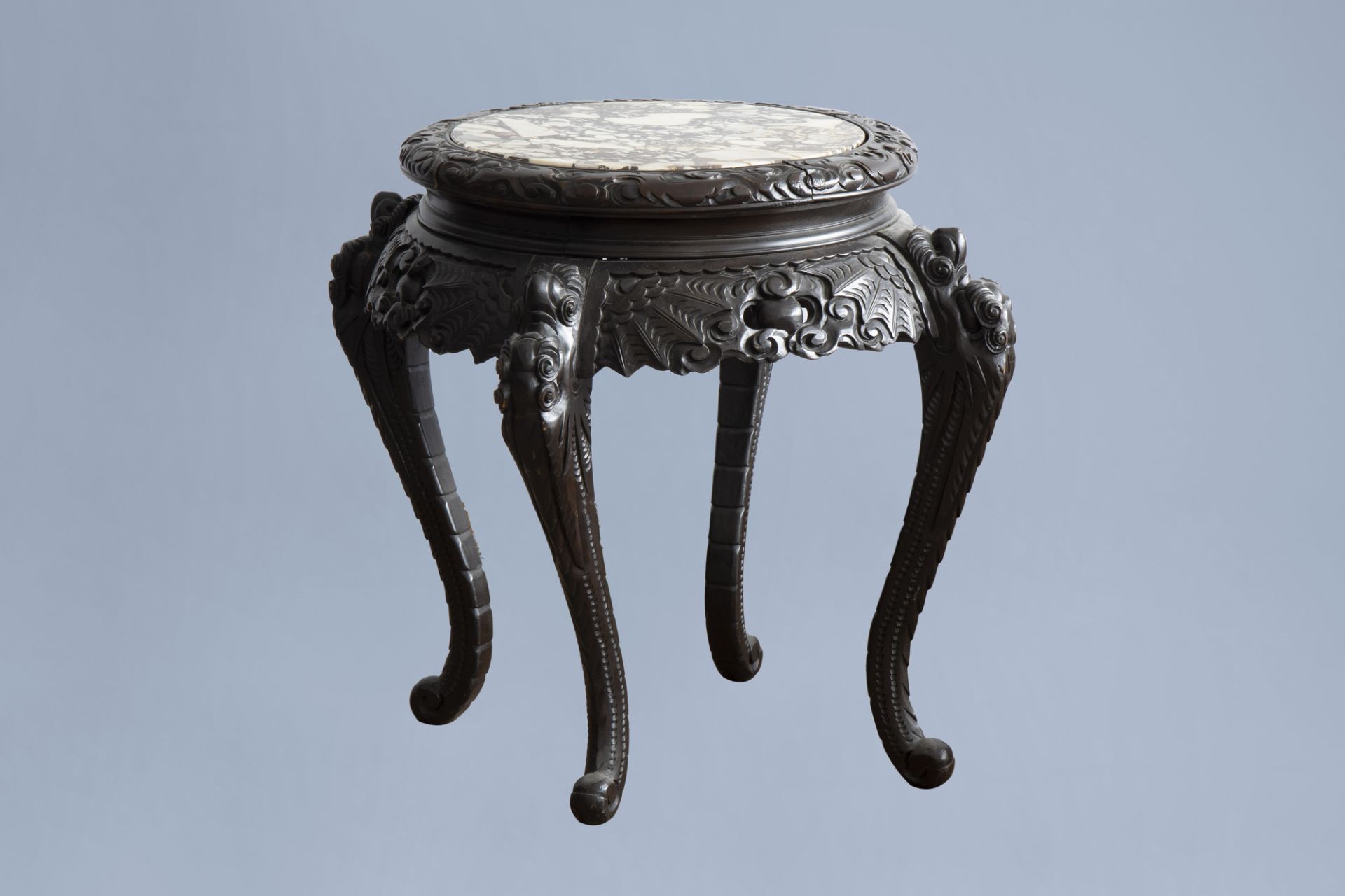 A Chinese or Japanese wooden table with marble top and dragon shaped legs, 20th C.